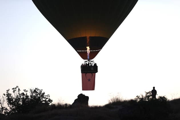 Cappadocia commemorates martyrs of 2016 defeated coup attempt NEVSEHIR, TURKIYE - JULY 14: Hot air balloons take off in Cappadocia carrying Turkish flags and banners featuring photographs of the 253 martyrs to commemorate July 15 Democracy and National Unity Day in Nevsehir, Turkiye on July 14, 2026. As part of the event organized by the Nevsehir Governorship, banners displaying Turkish flags and photographs of the martyrs were attached to the hot air balloons. Behcet Alkan Anadolu Nevsehir Turkey. Editorial use only. Please get in touch for any other usage.  Copyright: x2026xAnadoluxBehcetxAlkanx