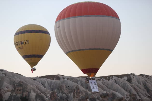 Cappadocia commemorates martyrs of 2016 defeated coup attempt NEVSEHIR, TURKIYE - JULY 14: Hot air balloons take off in Cappadocia carrying Turkish flags and banners featuring photographs of the 253 martyrs to commemorate July 15 Democracy and National Unity Day in Nevsehir, Turkiye on July 14, 2026. As part of the event organized by the Nevsehir Governorship, banners displaying Turkish flags and photographs of the martyrs were attached to the hot air balloons. Behcet Alkan Anadolu Nevsehir Turkey. Editorial use only. Please get in touch for any other usage.  Copyright: x2026xAnadoluxBehcetxAlkanx