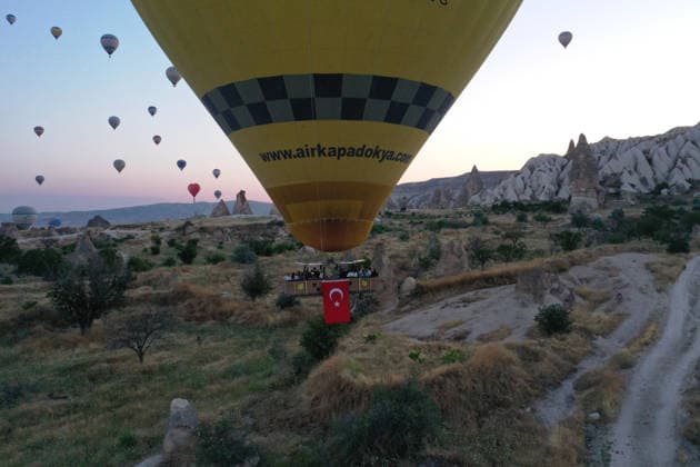 Cappadocia commemorates martyrs of 2016 defeated coup attempt NEVSEHIR, TURKIYE - JULY 14: Hot air balloons take off in Cappadocia carrying Turkish flags and banners featuring photographs of the 253 martyrs to commemorate July 15 Democracy and National Unity Day in Nevsehir, Turkiye on July 14, 2026. As part of the event organized by the Nevsehir Governorship, banners displaying Turkish flags and photographs of the martyrs were attached to the hot air balloons. Behcet Alkan Anadolu Nevsehir Turkey. Editorial use only. Please get in touch for any other usage.  Copyright: x2026xAnadoluxBehcetxAlkanx
