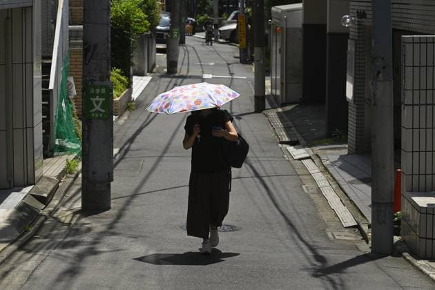 Extreme heat grips Tokyo as temperatures rise across eastern Japan TOKYO, JAPAN - JULY 14 : A pedestrian uses a parasol to protect herself from the sun while walking along a residential street during hot weather in Tokyo, Japan, July 14, 2026. Temperatures in central Tokyo were forecast to reach 34 degrees Celsius as intense heat spread across eastern Japan. David Mareuil Anadolu Tokyo Japan. Editorial use only. Please get in touch for any other usage.  Copyright: x2026xAnadoluxDavidxMareuilx