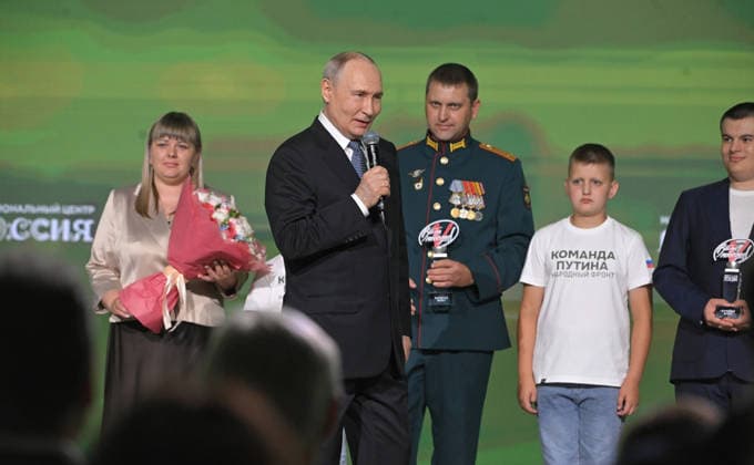 July 14, 2026, Moscow, Moscow Oblast, Russia: Russian President Vladimir Putin, left, congratulates the family of Andryus and Yulia Pozhyarskas, recipients of the Family of a Defender of the Fatherland award during the All-Russia People s Front Everything for Victory! forum at the Russia National Centre, July 13, 2026 in Moscow, Russia. Moscow Russia - ZUMAp138 20260714_zaa_p138_006 Copyright: xVyacheslavxProkofiev RussianxGovx