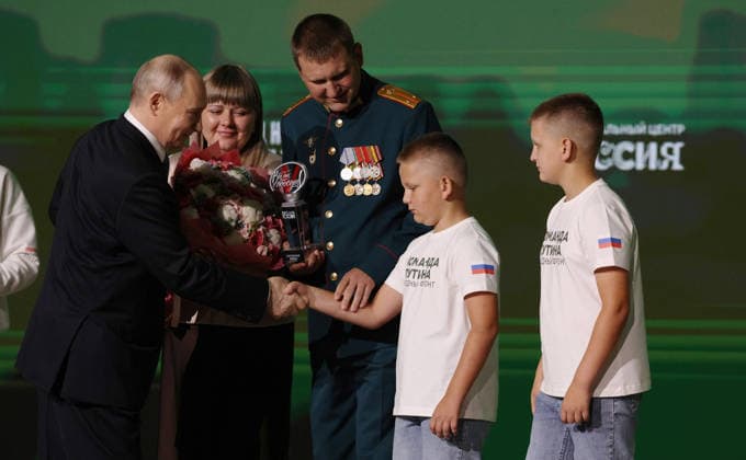 July 14, 2026, Moscow, Moscow Oblast, Russia: Russian President Vladimir Putin, left, congratulates the family of Andryus and Yulia Pozhyarskas, recipients of the Family of a Defender of the Fatherland award during the All-Russia People s Front Everything for Victory! forum at the Russia National Centre, July 13, 2026 in Moscow, Russia. Moscow Russia - ZUMAp138 20260714_zaa_p138_007 Copyright: xVyacheslavxProkofiev RussianxGovx