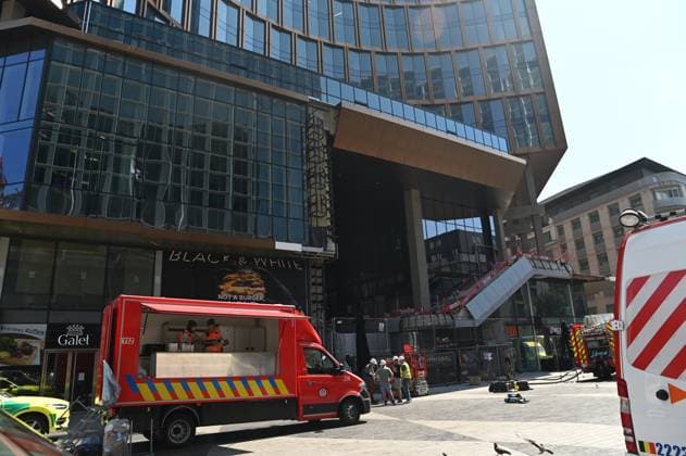 the scene of a fire at the OXY building at place De Brouckere, in Brussels, Tuesday 14 July 2026s. The Brussels Labour Inspectorate confirms several bodies were found in the lift shafts, 6 people are still missing. The fire broke out on the second floor of the building that is currently being renovated.  EMILExWINDAL 181120358