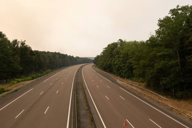 (260714) -- SEINE-ET-MARNE, July 14, 2026 -- This photo taken on July 14, 2026 shows a closed road due to a wildfire in Seine-et-Marne, France. French police have detained 59 people across the country in connection with wildfires, including two suspects linked to the blaze in the Fontainebleau forest in Seine-et-Marne department, southeast of Paris, French Interior Minister Laurent Nunez said on Monday. The wildfire in the Fontainebleau forest broke out on Sunday evening and continued to spread on Monday. ) FRANCE-SEINE-ET-MARNE-FONTAINEBLEAU-WILDFIRE WuxHuiwo 
