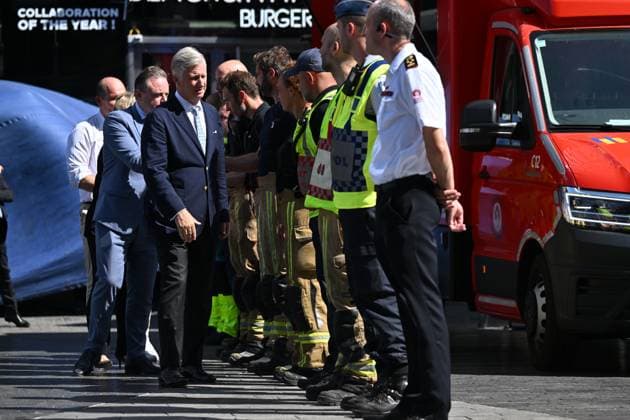 Prime Minister Bart de Wever, King Philippe - Filip of Belgium and pictured at the scene of a fire at the OXY building at place De Brouckere, in Brussels, Tuesday 14 July 2026s. The Brussels Labour Inspectorate confirms several bodies were found in the lift shafts, 6 people are still missing. The fire broke out on the second floor of the building that is currently being renovated.  EMILExWINDAL 181130201