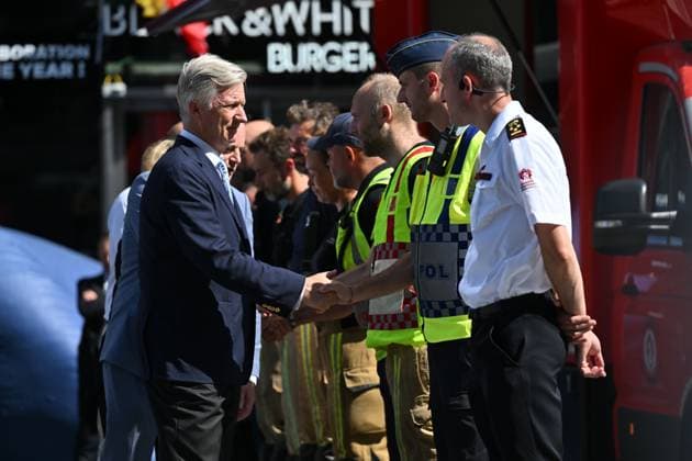 Prime Minister Bart de Wever, King Philippe - Filip of Belgium and pictured at the scene of a fire at the OXY building at place De Brouckere, in Brussels, Tuesday 14 July 2026s. The Brussels Labour Inspectorate confirms several bodies were found in the lift shafts, 6 people are still missing. The fire broke out on the second floor of the building that is currently being renovated.  EMILExWINDAL 181130437