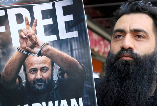 July 14, 2026, Nablus, Palestine: A Palestinian man holds up a portrait of leader Marwan Barghouti during a demonstration in downtown Nablus in the West Bank, demanding his release from Israeli prisons. Released prisoners said that prison guards fired rubber bullets at the Palestinian leader Marwan Barghouti inside his cell. Barghouti is serving five life sentences plus forty years, and has spent more than twenty-four years in Israeli prison. Nablus Palestine - ZUMAs197 20260714_aaa_s197_092 Copyright: xNasserxishatyehx