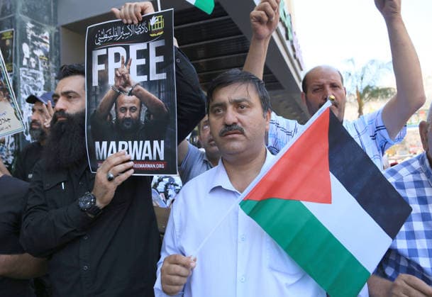 July 14, 2026, Nablus, Palestine: A Palestinian man holds up a portrait of leader Marwan Barghouti during a demonstration in downtown Nablus in the West Bank, demanding his release from Israeli prison. Released prisoners said that prison guards fired rubber bullets at the Palestinian leader Marwan Barghouti inside his cell. Barghouti is serving five life sentences plus forty years, and has spent more than twenty-four years in Israeli prison. Nablus Palestine  - ZUMAs197 20260714_aaa_s197_094 Copyright: xNasserxishatyehx