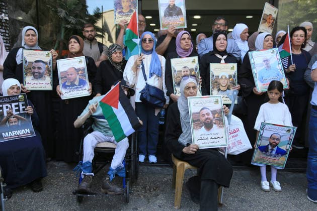 July 14, 2026, Nablus, Palestine: Palestinians hold portraits of their relatives held inside israeli prisons, during a demonstration in downtown Nablus in the West Bank, demanding their release. Released prisoners said that prison guards fired rubber bullets at the Palestinian leader Marwan Barghouti inside his cell. Barghouti is serving five life sentences plus forty years, and has spent more than twenty-four years in Israeli prison. Nablus Palestine - ZUMAs197 20260714_aaa_s197_098 Copyright: xNasserxishatyehx