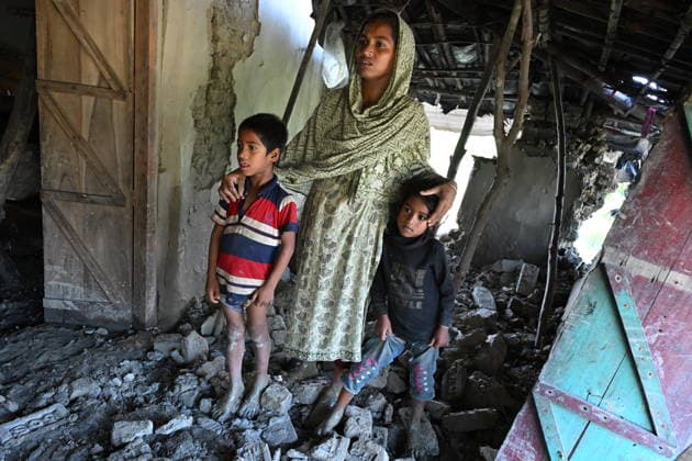July 14, 2026, Banshkhali, Chattogram, Bangladesh: A woman and two children stand among collapsed walls and debris inside their flood-damaged home after floodwaters receded. Severe flooding across Chattogram Division has killed at least 54 and affected or displaced more than 1 million people across the country according to thre UN. Banshkhali Bangladesh  - ZUMAh178 20260714_zip_h178_007 Copyright: xMuhammadxAmdadxHossainx