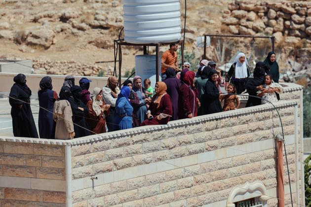 Hebron West Bank Home Demolition Palestinian residents gather near a home during an Israeli demolition operation in Al-Deirat, south of Hebron, occupied West Bank on July 14, 2026. Israeli forces demolish the home of Osama Masaaf on the grounds that it lacked an Israeli-issued building permit, displacing a Palestinian family of eight. Hebron West Bank Palestinian Territories Copyright: xMosabxShawerx