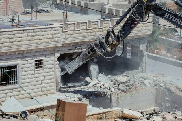 Hebron West Bank Home Demolition An excavator operates during a home demolition in Al-Deirat, south of Hebron, occupied West Bank on July 14, 2026. Israeli forces demolish the home of Osama Masaaf on the grounds that it lacked an Israeli-issued building permit, displacing a Palestinian family of eight. Hebron West Bank Palestinian Territories Copyright: xMosabxShawerx