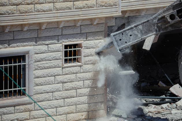 Hebron West Bank Home Demolition An excavator operates during a home demolition in Al-Deirat, south of Hebron, occupied West Bank on July 14, 2026. Israeli forces demolish the home of Osama Masaaf on the grounds that it lacked an Israeli-issued building permit, displacing a Palestinian family of eight. Hebron West Bank Palestinian Territories Copyright: xMosabxShawerx