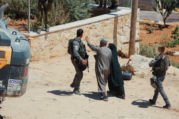 Hebron West Bank Home Demolition A Palestinian man and woman speak with an Israeli security officer during a home demolition operation in Al-Deirat, south of Hebron, occupied West Bank on July 14, 2026. Israeli forces demolish the home of Osama Masaaf on the grounds that it lacked an Israeli-issued building permit, displacing a Palestinian family of eight. Hebron West Bank Palestinian Territories Copyright: xMosabxShawerx