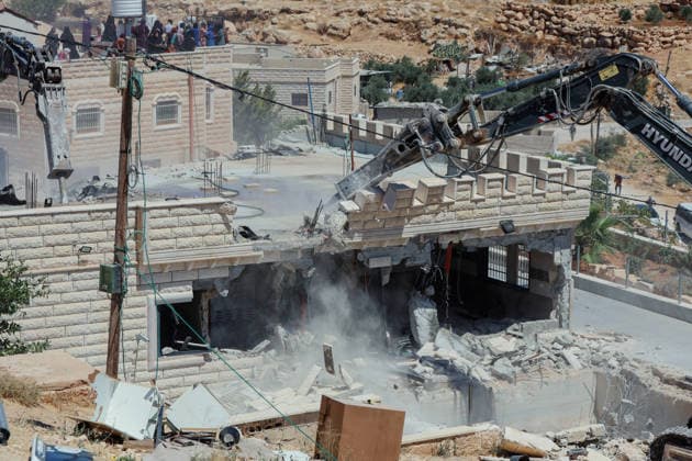 Hebron West Bank Home Demolition An excavator operates during a home demolition in Al-Deirat, south of Hebron, occupied West Bank on July 14, 2026. Israeli forces demolish the home of Osama Masaaf on the grounds that it lacked an Israeli-issued building permit, displacing a Palestinian family of eight. Hebron West Bank Palestinian Territories Copyright: xMosabxShawerx