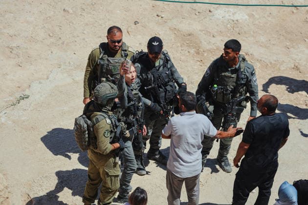 Hebron West Bank Home Demolition Palestinian men speak with Israeli forces during a home demolition operation in Al-Deirat, south of Hebron, occupied West Bank on July 14, 2026. Israeli forces demolish the home of Osama Masaaf on the grounds that it lacked an Israeli-issued building permit, displacing a Palestinian family of eight. Hebron West Bank Palestinian Territories Copyright: xMosabxShawerx