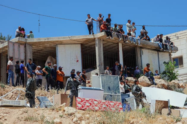 Hebron West Bank Home Demolition Palestinian residents gather outside a home during an Israeli demolition operation in Al-Deirat, south of Hebron, occupied West Bank on July 14, 2026. Israeli forces demolish the home of Osama Masaaf on the grounds that it lacked an Israeli-issued building permit, displacing a Palestinian family of eight. Hebron West Bank Palestinian Territories Copyright: xMosabxShawerx