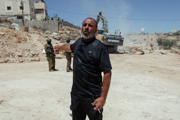 Hebron West Bank Home Demolition A Palestinian man walks near the rubble of the demolished home of Osama Masaaf s family in Al-Deirat, south of Hebron, occupied West Bank on July 14, 2026. Israeli forces demolish the house on the grounds that it lacked an Israeli-issued building permit, displacing the family of eight. Hebron West Bank Palestinian Territories Copyright: xMosabxShawerx