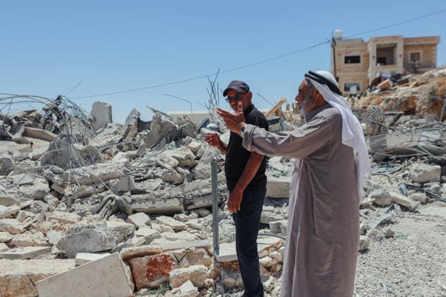 Hebron West Bank Home Demolition Palestinian residents stand near the rubble of the demolished home of Osama Masaaf s family in Al-Deirat, south of Hebron, occupied West Bank on July 14, 2026. Israeli forces demolish the house on the grounds that it lacked an Israeli-issued building permit, displacing the family of eight. Hebron West Bank Palestinian Territories Copyright: xMosabxShawerx