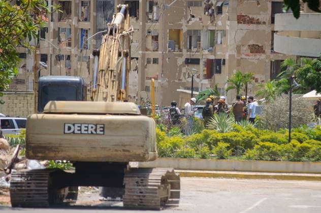 July 14, 2026, La Guaira, Venezuela (Bolivarian Republic of: PLAYA GRANDE, LA GUAIRA, VENEZUELA Ã¢â‚¬ JULY 14, 2026: Excavators and civil carry out controlled demolition and debris removal operations in the coastal community of Playa Grande, one of the areas hardest hit by the earthquake that struck northern Venezuela 20 days earlier. The operations have entered the recovery phase, focusing on clearing major roads blocked by collapsed residential buildings to restore access and mobility for residents as reconstruction efforts continue. JNA Press. La Guaira Venezuela (Bolivarian Republic of - ZUMAq101 20260714_zna_q101_185 Copyright: xMarioxFloresx