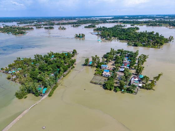 Aftermath Of Floodwaters In Chattogram A broad drone view captures scattered rural neighborhoods completely cut off and transformed into isolated islands by devastating flash floods in Banshkhali, Chattogram, Bangladesh, on July 14, 2026. Although the flood waters in Banshkhali and Satkania in Chittagong are slowly receding.Many areas are still knee-deep in water, and as the water recedes, collapsed mud houses, damaged structures, destroyed brick kilns and severely damaged agricultural land are becoming visible, displacing thousands of people and leaving them struggling to meet their basic needs. Chattogram Bangladesh  Copyright: xZakirxHossainx originalFilename: hossain-notitle260714_npcUA.jpg