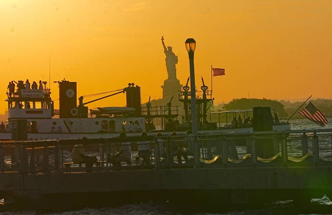 A dramatic colorful sky during sunset in New York NEW YORK CITY, UNITED STATES - JULY 14: A view of the Statue of Liberty during sunset on July 14, 2026 in New York City, United States. Selcuk Acar Anadolu New York United States. Editorial use only. Please get in touch for any other usage.  Copyright: x2026xAnadoluxSelcukxAcarx