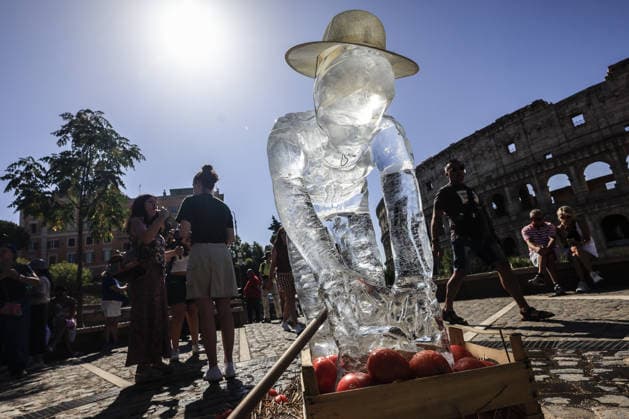 Greenpeace action on impact of global warming on workers in Italy ROME, ITALY, JULY 15: Ice statues representing a farm worker, a construction worker and a food delivery rider stand in front of the Colosseum after being placed by Greenpeace activists to melt under the sun during an awareness campaign highlighting the impact of global warming on workers, as a new heatwave grips in Rome, Italy on July 15, 2026. Seven cities were placed under a red alert on Wednesday, with the number expected to rise on Thursday, July 16, and temperatures forecast to exceed 40 degrees Celsius in many areas. Riccardo De Luca Anadolu Rome Italy. Editorial use only. Please get in touch for any other usage.  Copyright: x2026xAnadoluxRiccardoxDexLucax