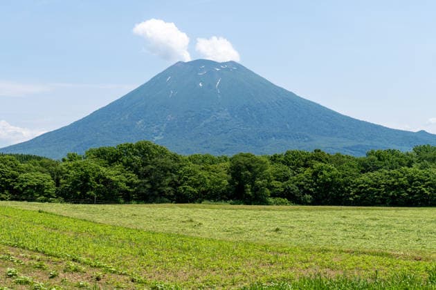 Hokkaido, Japan June 17, 2026: Mount Yotei (Yoteizan) rises above the landscape in Hokkaido, Japan. This nearly symmetrical stratovolcano, with its remaining snowfields, is one of the most striking natural landmarks in the Niseko region and a popular destination for hikers and nature tourists