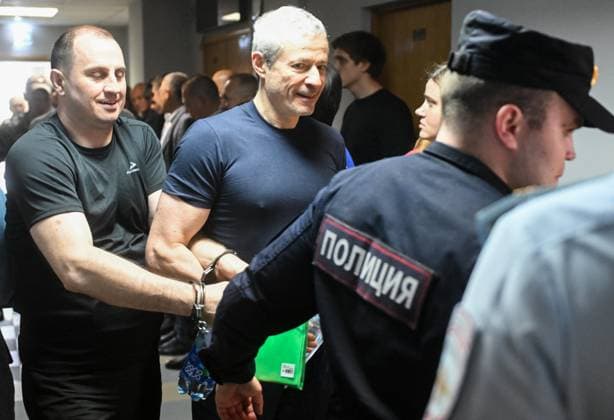 Russia Rusagro Founder Fraud Trial 9205852 15.07.2026 Founder of Russian agricultural giant Rusagro Group Vadim Moshkovich, charged with large-scale fraud and organising abuse of office in connection with the corruption case against the company, is escorted by police before a hearing at the Zamoskvoretsky District Court in Moscow, Russia. Mikhail Voskresenskiy Sputnik Moscow Russia  Copyright: xMikhailxVoskresenskiyx