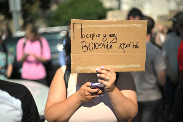A demonstrator holds a placard reading Shot in Leg of Warring Country during a rally against the dismissal of Ukrainian Defence Minister Mykhailo Fedorov, Kyiv, Ukraine, July 16, 2026. On July 14, the Ukrainian Parliament supported the resignation of Prime Minister Yuliia Svyrydenko, leading to the resignation of the Cabinet of Ministers. (Photo by Yevhen Kotenko Ukrinform) Protest action against dismissal of Ukrainian Defence Minister Mykhailo Fedorov in Kyiv  Copyright: xYevhenxKotenkox