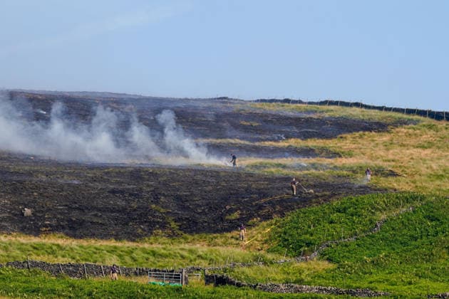 July 16, 2026, Glossop, Derbyshire, UK: Glossop, UK. Firefighters tackle a massive moorland wildfire on Tintwistle Moor in Glossop, Derbyshire. Glossop UK  - ZUMAl94_ 20260716_zaf_l94_013 Copyright: xIoannisxAlexopoulosx