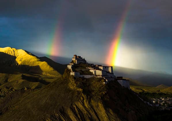 SHIGATSE CHINA - JULY 16: Double rainbow hangs in the sky above Jiangzi Zongshan Castle on July 16, 2026 in Jiangzi, Xizang Autonomous Region of China.  Copyright: xVCGx 111654720363