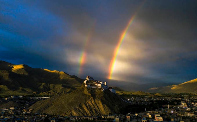SHIGATSE CHINA - JULY 16: Double rainbow hangs in the sky above Jiangzi Zongshan Castle on July 16, 2026 in Jiangzi, Xizang Autonomous Region of China.  Copyright: xVCGx 111654720370