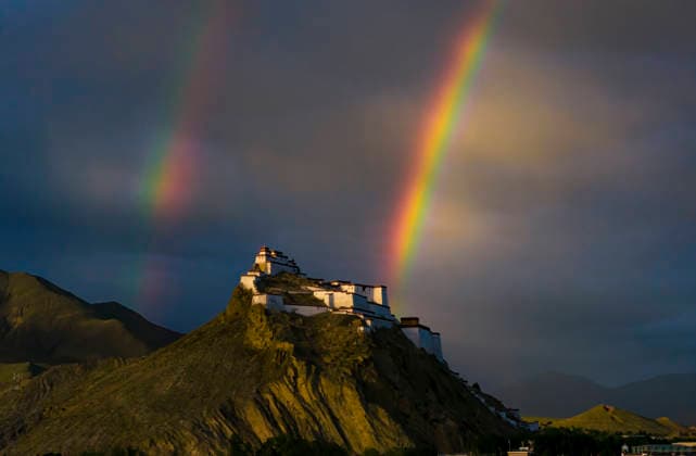 SHIGATSE CHINA - JULY 16: Double rainbow hangs in the sky above Jiangzi Zongshan Castle on July 16, 2026 in Jiangzi, Xizang Autonomous Region of China.  Copyright: xVCGx 111654720369