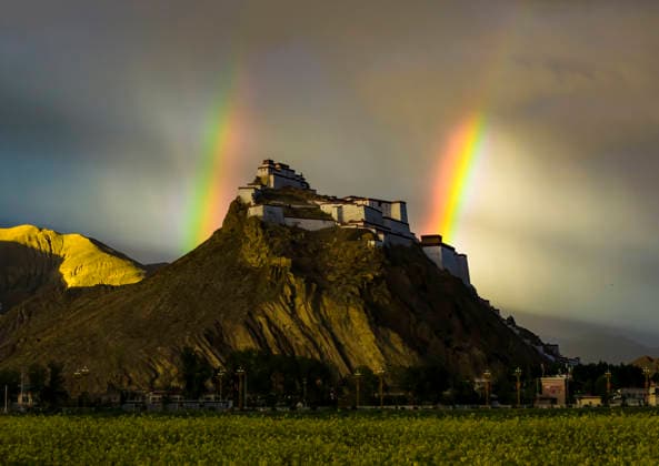 SHIGATSE CHINA - JULY 16: Double rainbow hangs in the sky above Jiangzi Zongshan Castle on July 16, 2026 in Jiangzi, Xizang Autonomous Region of China.  Copyright: xVCGx 111654720364