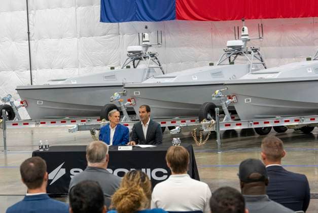 July 16, 2026, Austin, Tx, USA: Texas Governor GREG ABBOTT announces with Saronic CEO DINO MAVROOKAS the expansion to south Texas of the ship and drone boat manufacturer Saronic to a 1,000 acre site at the Port of Brownsville. The Saronic Corsair in the background were the type of drones used to rescue downed U.S. pilots in the Gulf of Oman and attack naval facilities in Iraq. Austin USA  - ZUMAd150 20260716_znp_d150_008 Copyright: xBobxDaemmrichx