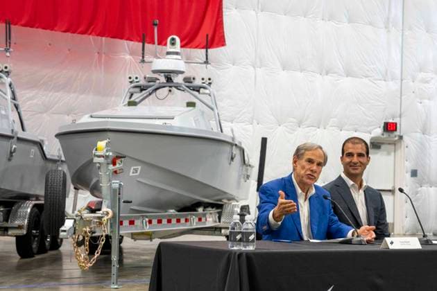July 16, 2026, Austin, Tx, USA: Texas Governor GREG ABBOTT announces with Saronic CEO DINO MAVROOKAS the expansion to south Texas of the ship and drone boat manufacturer Saronic to a 1,000 acre site at the Port of Brownsville. The Saronic Corsair in the background were the type of drones used to rescue downed U.S. pilots in the Gulf of Oman and attack naval facilities in Iraq. Austin USA  - ZUMAd150 20260716_znp_d150_011 Copyright: xBobxDaemmrichx