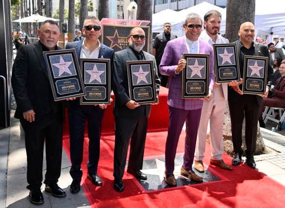 Intocable band members Sergio Serna, Alejandro Gulmar, Johnny Lee Rosas, Ricardo Munoz, Rene Martinez and Feliz Salinas (L-R) hold replica plaques during their Hollywood Walk of Fame star ceremony honoring the band with the 2,852nd star on the Hollywood Walk of Fame in Los Angeles on Thursday, July 16, 2026.  LAP2026071612 JIMxRUYMEN