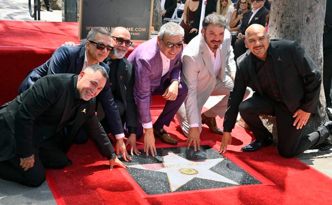 Intocable band members Sergio Serna, Alejandro Gulmar, Johnny Lee Rosas, Ricardo Munoz, Rene Martinez and Feliz Salinas (L-R) touch their star during their Hollywood Walk of Fame star ceremony honoring the band with the 2,852nd star on the Hollywood Walk of Fame in Los Angeles on Thursday, July 16, 2026.  LAP2026071613 JIMxRUYMEN