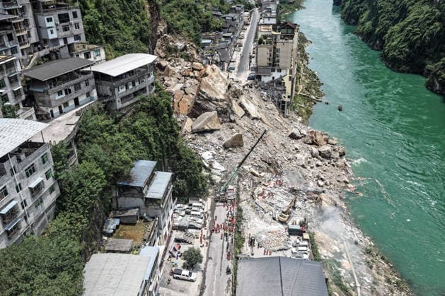 (260717) -- CHONGQING, July 17, 2026 -- An aerial drone photo taken on July 17, 2026 shows the site of a rainfall-induced landslide along a section of the Wujiang River in southwest China s Chongqing Municipality. Nine people have so far been rescued after a rainfall-induced landslide occurred along a section of the Wujiang River in southwest China s Chongqing Municipality on Friday. None of those rescued sustained life-threatening injuries, according to local authorities of Pengshui Miao and Tujia Autonomous County in Chongqing. The geological disaster saw massive amounts of rock and soil wash downslope at 9:08 a.m. Friday, burying more than 10 residential buildings, leaving local residents trapped and unaccounted for. ) (SpotNews) 