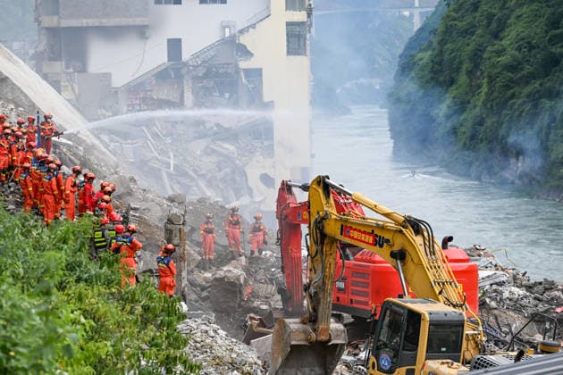 (260718) -- CHONGQING, July 18, 2026 -- Rescuers work at the site of a mountain collapse in Pengshui Miao and Tujia Autonomous County, southwest China s Chongqing Municipality, July 17, 2026. Eight people have been confirmed dead and 34 others remain missing after a rainfall-induced mountain collapse occurred along a section of the Wujiang River in southwest China s Chongqing Municipality on Friday, local authorities said. Ten people have been rescued, and search and rescue operations are underway, according to a press briefing held on Friday night. The geological disaster occurred at 9:08 a.m. on Friday in the Hanjia sub-district of Pengshui Miao and Tujia Autonomous County in Chongqing, burying more than 10 residential buildings, w 