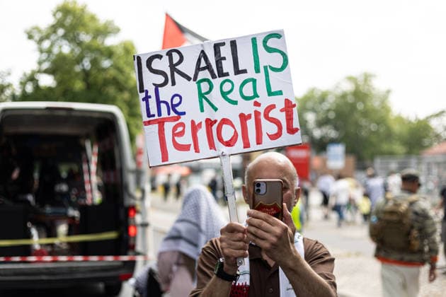 Pro-Palestinian demonstration in Berlin, Germany- 18 Jul 2026 A male activist holds a placard reading Israel is the real terrorist during a pro-Palestinian demonstration near Tempelhof Airport. Hundreds of people marched through the city center with drums, some wearing keffiyehs, traditional Palestinian scarves, while calling for an end to the wars in the Gaza Strip and Iran. Berlin Germany Copyright: xVasilyxKrestyaninovx xSOPAxImagesx _VKR5377