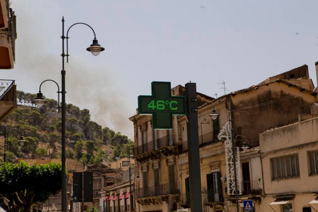 Modica Italy Heatwave A pharmacy sign displays a temperature of 46 degrees Celsius during a heatwave as smoke from a wildfire rises in the background in Modica, Sicily, Italy, on July 18, 2026. A wildfire affected areas of Sicily as high temperatures persisted across southern Italy. Modica Ragusa Italy Copyright: xElvisxTakahashixMantellox