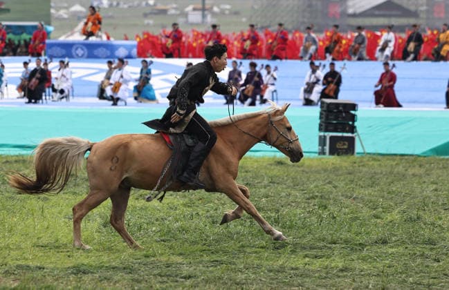 XILINGOL, CHINA - JULY 18: An artist performs with a horse at the opening ceremony of the 36th Naadam festival on July 18, 2026 in Xilingol League, Inner Mongolia Autonomous Region of China. The Naadam festival kicked off here on July 18. Naadam, usually held in mid-summer and sometimes in winter in pastoral areas of Inner Mongolia, means games in the Mongolian language. It often comprises wrestling, archery, and horse racing, also known as the Three Games of Men.  Copyright: xVCGx 111655158216