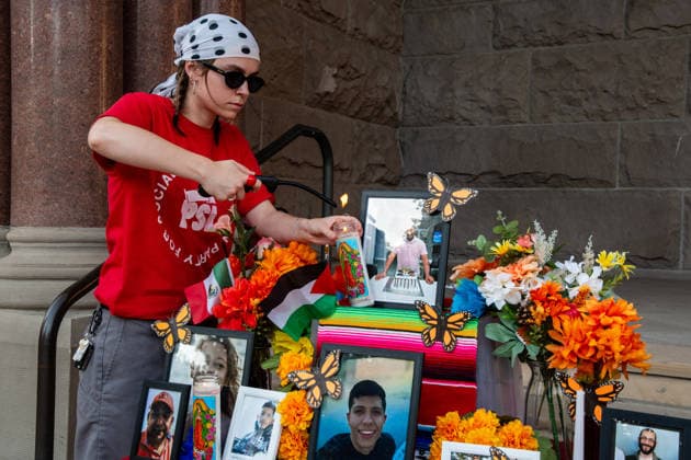 July 18, 2026, Salt Lake City, Utah, USA: A protester lights candles at a temporary altar featuring flowers and photographs of various victims outside the Salt Lake City and County Building at Washington Square Park during an ICE OUT protest in Salt Lake City, Utah, on Saturday, July 18, 2026. The demonstration was organized to contest immigration policy following the recent fatal shootings of Lorenzo Salgado Araujo and Joan Sebastian Guerrero by federal immigration law enforcement agents. Salt Lake City USA  - ZUMAm292 20260718_znp_m292_001 Copyright: xCharlesxMcClintockxWilsonx