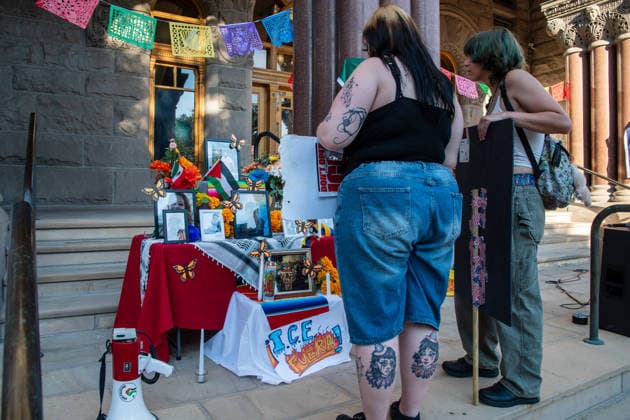 July 18, 2026, Salt Lake City, Utah, USA: Protesters stand near a temporary altar featuring flowers and photographs of various victims outside the Salt Lake City and County Building at Washington Square Park during an ICE OUT protest in Salt Lake City, Utah, on Saturday, July 18, 2026. The demonstration was organized to contest immigration policy following the recent fatal shootings of Lorenzo Salgado Araujo and Joan Sebastian Guerrero by federal immigration law enforcement agents. Salt Lake City USA  - ZUMAm292 20260718_znp_m292_011 Copyright: xCharlesxMcClintockxWilsonx