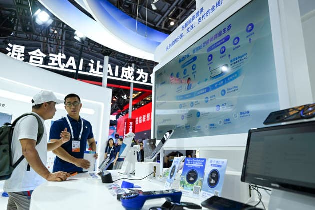 (260719) -- SHANGHAI, July 19, 2026 -- A staff member (R) introduces the agent business ecosystem to a visitor at the booth of Ant Group during the 2026 World AI Conference and High-Level Meeting on Global AI Governance in Shanghai, east China, July 19, 2026. The event scheduled from Friday to Monday showcases exhibitions of a number of AI agent hardware and system products, highlighting the transition of next-generation AI from a tool to an intelligent partner, empowering various industries and everyday life. ) CHINA-SHANGHAI-WORLD AI CONFERENCE-AI PRODUCTS (CN) ChenxHaoming 