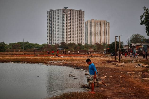 July 19, 2026, Jakarta, Indonesia: JAKARTA, INDONESIA Ã¢â‚¬ JULY 19, 2026: Children sit and play outside a house in Kampung Muara Baru, North Jakarta. According to the Jakarta Public Housing and Settlement Agency (DPRKP), high population density, limited land for infrastructure development, zoning constraints and land tenure issues remain among the main challenges to improving informal settlements in the Indonesian capital. JNA Press Jakarta Indonesia  - ZUMAq101 20260719_zna_q101_085 Copyright: xMuhammadxRizkyxFebriansyahx