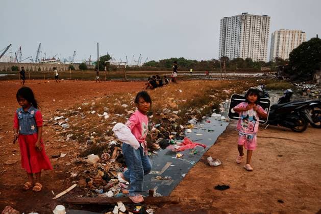 July 19, 2026, Jakarta, Indonesia: JAKARTA, INDONESIA Ã¢â‚¬ JULY 19, 2026: Children sit and play outside a house in Kampung Muara Baru, North Jakarta. According to the Jakarta Public Housing and Settlement Agency (DPRKP), high population density, limited land for infrastructure development, zoning constraints and land tenure issues remain among the main challenges to improving informal settlements in the Indonesian capital. JNA Press Jakarta Indonesia - ZUMAq101 20260719_zna_q101_088 Copyright: xMuhammadxRizkyxFebriansyahx
