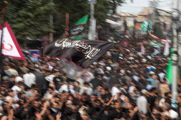 July 19, 2026, Budgam, Jammu And Kashmir, India: A Shiite Muslim waves a religious flag during a procession on the fourth day of Safar in Magam. Safar, the second month of the Islamic calendar, follows Muharram and continues the mourning of Imam Hussain. According to Shia tradition, the 4th of safar, 61 AH, marks the imprisonment of the Prophet s household (Ahl al-Bayt) in Kufa under the orders of Ubaydullah ibn Ziyad after the Battle of Karbala. Budgam India  - ZUMAa205 20260719_zip_a205_002 Copyright: xAdilxAbassx